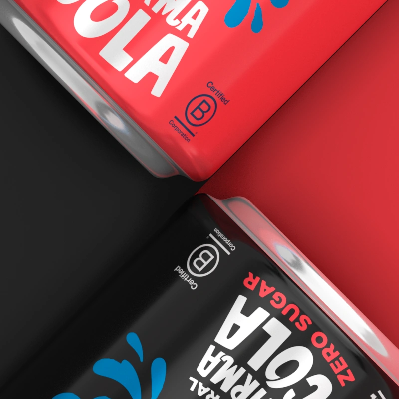 Closeup of Two white cans of Karma Drinks with "No Sugar" and "No Added Sugar" labels.