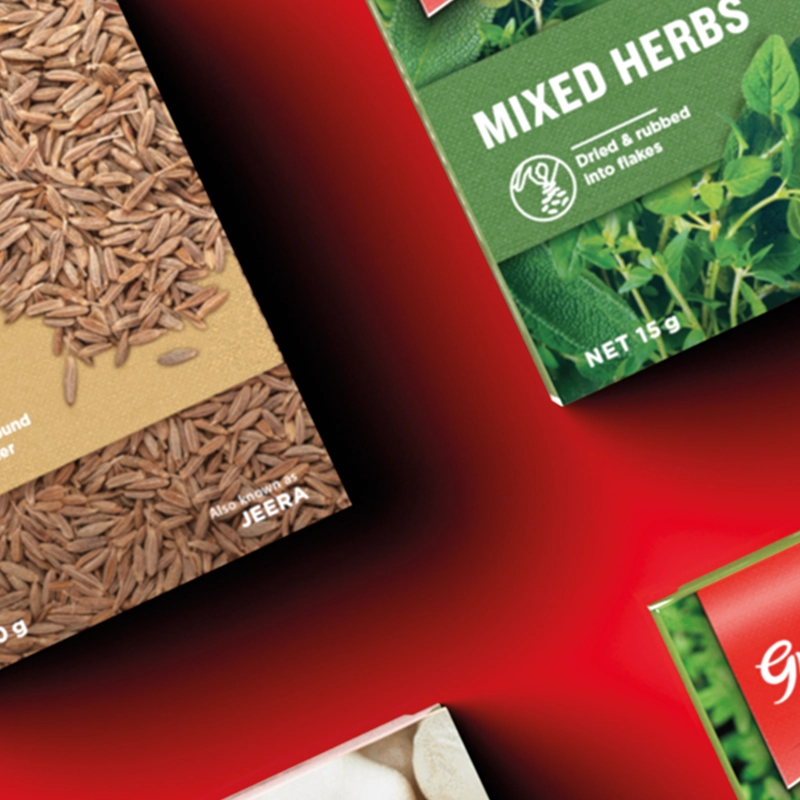 Closeup of Gregg's spices and herbs boxes on a red background.