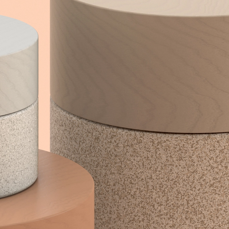 Closeup of three cylindrical containers with different textures: smooth wood, speckled brown and a rough, sandy texture.