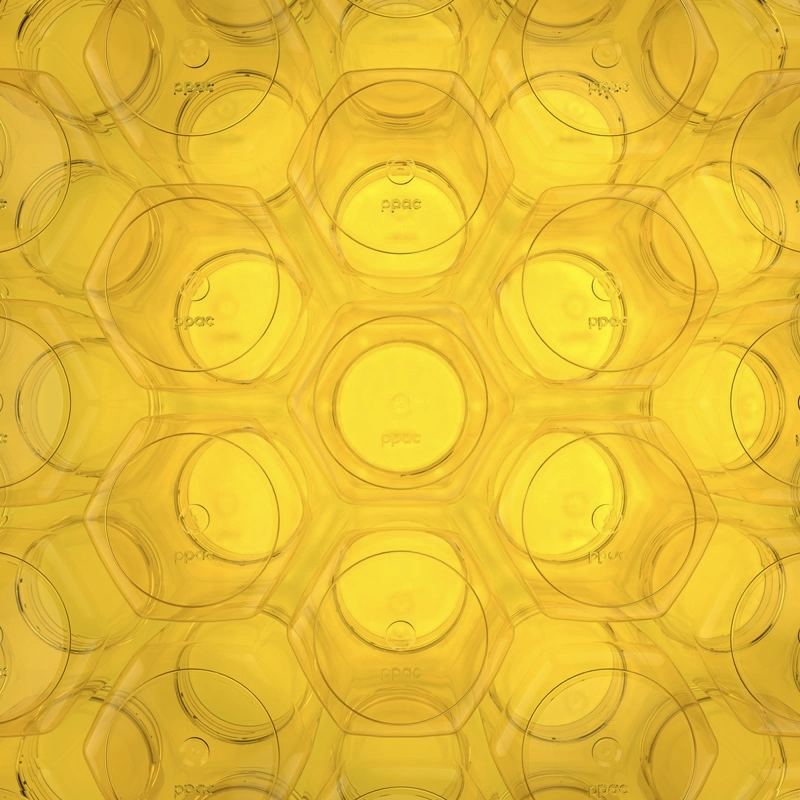 Closeup of a repeating pattern of hexagon-shaped plastic jars with a yellow background.