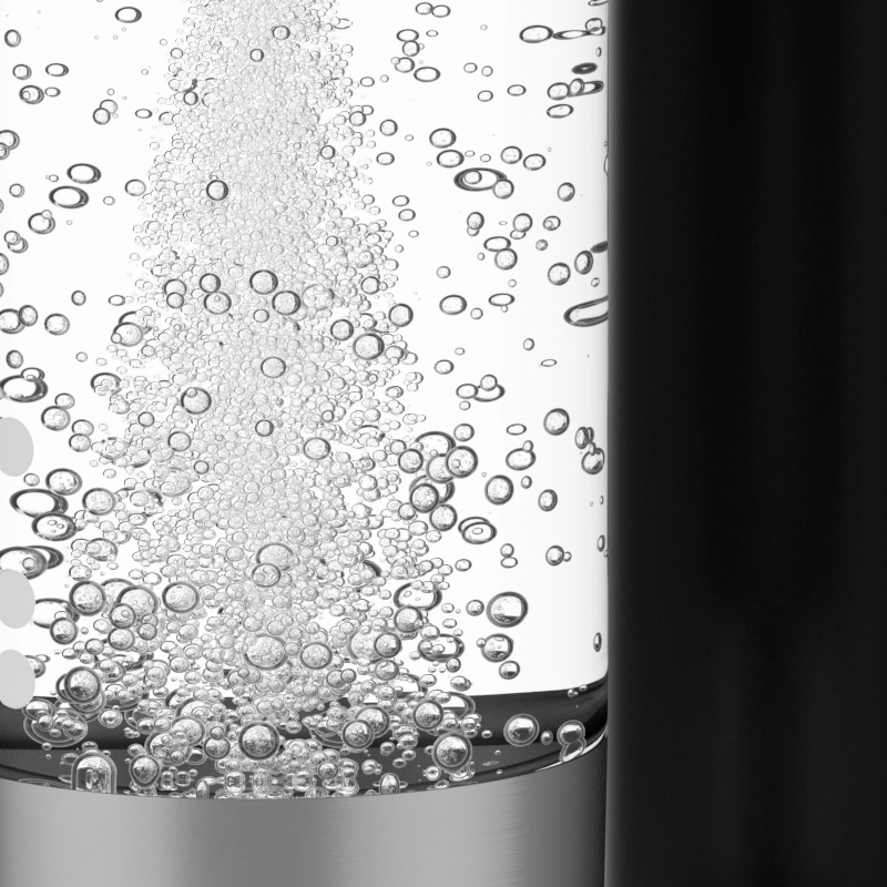 A close-up of a glass bottle with a silver base, filled with water and many small bubbles rising to the surface.